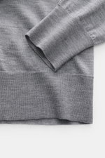 Close-up view of the Ami Paris Merino cardigan grey mottled sleeve and hem, showing fine knit and ribbed bands.

<p>Timelessly elegant: The AMI PARIS cardigan, with its knit turn-down collar and pure merino wool fabric, is a comfortable choice for both th