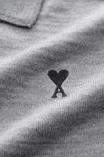 Close-up front view of Ami Paris Merino cardigan grey mottled showing fine knit texture and black heart logo stitching on chest.

<p>Timelessly elegant: The AMI PARIS cardigan, with its knit turn-down collar and pure merino wool fabric, is a comfortable c