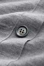 Close-up front view of Ami Paris Merino cardigan grey mottled showing knit fabric texture and a branded button.

<p>Timelessly elegant: The AMI PARIS cardigan, with its knit turn-down collar and pure merino wool fabric, is a comfortable choice for both th