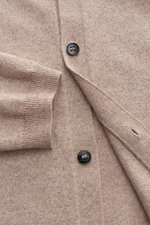 Close-up top-down view of von Braun Cashmere knit shirt beige showing fine knit fabric, black buttons, ribbed cuff, and smooth button placket.

<p>Luxurious winter essential: This VON BRAUN knit shirt in the finest Mongolian cashmere has a timeless design