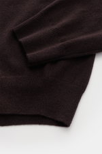 Close-up top-down view of the sleeve and bottom hem of the von Braun Cashmere half-zip jumper dark brown, highlighting its fine knit and flexible ribbed bands. 

<p>This clean VON BRAUN half-zip jumper made from high-quality and exceptionally fine Mongoli