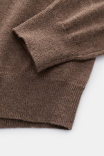 Close-up from above of the sleeve and hem of the von Braun Cashmere half-zip jumper brown mottled, showing fine knit texture and ribbed bands. 

<p>This clean VON BRAUN half-zip jumper made from high-quality and exceptionally fine Mongolian cashmere combi