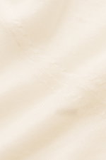 Close-up detailed view of cream-colored von Braun Merino fine knit polo fabric showing smooth, soft texture and fine knit pattern.

Description: 
<p>Pure Merino wool in a comfortable fine knit makes this knit polo from the brand VON BRAUN a luxurious e