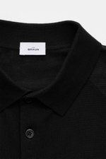 Close-up front view of von Braun Merino fine knit polo black with narrow collar, three-button placket, and smooth fine knit texture.

Description: <p>Pure Merino wool in a comfortable fine knit makes this knit polo from the brand VON BRAUN a luxurious ess