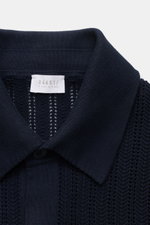 Close-up front view of the 04651/ A trip in a bag Short sleeve knit shirt narrow collar navy, showing textured knit and narrow collar.

<p>Summery ease: With a casual cut and comfortable cotton, this short sleeve knit shirt by 04651/ A TRIP IN A BAG is th