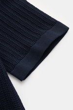 Close-up of the sleeve hem of the 04651/ A trip in a bag Short sleeve knit shirt narrow collar navy, showing textured knit detail from a top angle.

<p>Summery ease: With a casual cut and comfortable cotton, this short sleeve knit shirt by 04651/ A TRIP I