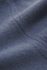 Nahaufnahme des graublauen Colombo Cashmere Strickpolo aus reinem Kid Cashmere, zeigt feines Strickbild und weichen Griff, Perspektive von oben.
