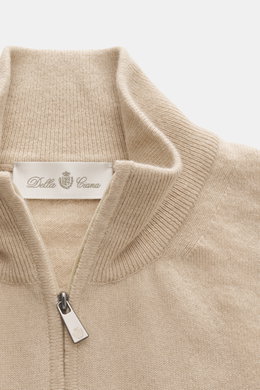 Della Ciana Troyer beige in Nahaufnahme von oben, Mix aus Cashmere und Merinowolle, weicher Griff, feines Strickbild, Regular Fit, Troyer-Kragen mit Reißverschluss, flexible Rippbündchen.