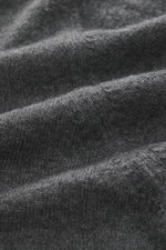 Nahaufnahme des feinen Strickbildes des dunkelgrau melierten Della Ciana Troyer, fotografiert aus seitlicher Perspektive, mit weichem Griff, Mix aus Cashmere und Merinowolle, Regular Fit, Troyer-Kragen mit Reißverschluss und flexiblen Rippbündchen.
