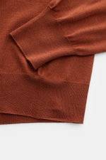 Gran Sasso Fine knit polo rust brown shown from a close-up top-down view highlighting the sleeve cuff and hem, crafted from a luxurious blend of virgin wool, cashmere, and silk with a very soft feel, fine knit, slim fit, signature collar, smooth four-butt