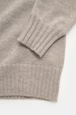 Nahaufnahme des FTC Cashmere Troyer sand meliert mit feinem Strickbild, Rippbündchen und weichem Cashmere von schräg oben fotografiert.