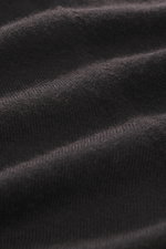Nahaufnahme des FTC Strickpolo dunkelbraun aus Cashmere und Lyocell mit sehr feinem Strickbild und softem Griff, Detailansicht des Materials.