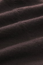 Close-up front view of B.F. Knitwear Merino knit polo dark violet showing fine knit pattern, soft feel, pure merino wool, regular fit, classic polo collar, and flexible ribbed cuffs.