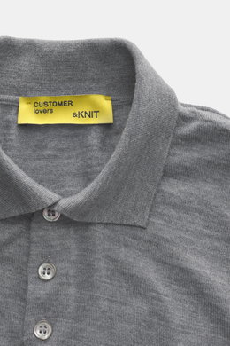 Close-up top-front view of B.F. Knitwear Merino knit polo grey melange showing classic polo collar, buttons, fine knit pattern, soft feel, regular fit, flexible ribbed cuffs, knit from pure merino wool.
