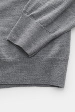 Close-up top-down view of the sleeve and hem of the B.F. Knitwear Merino knit polo grey melange, knit from pure merino wool with a soft feel, fine knit pattern, regular fit, classic polo collar, and flexible ribbed cuffs.