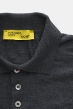 Close-up front view of B.F. Knitwear Merino knit polo dark grey melange, knit from pure merino wool, soft feel, fine knit pattern, regular fit, classic polo collar, flexible ribbed cuffs.