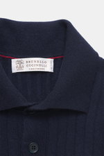 Brunello Cucinelli Cashmere knitted polo navy close-up from above showing wide rib knit, knitted collar, four-button placket, ribbed cuffs, pure cashmere, soft touch, slim fit. 

<p>Timeless essential for the refined men's wardrobe: BRUNELLO CUCINELLI has