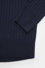 Close-up front view of the Brunello Cucinelli Cashmere knitted polo navy sleeve and side showing wide rib knit and soft pure cashmere fabric.

Description: 
<p>Timeless essential for the refined men's wardrobe: BRUNELLO CUCINELLI has chosen pure cashmere 