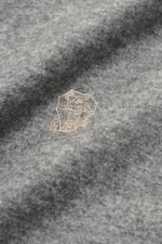 Close-up front view of the Brunello Cucinelli Cashmere quarter-zip jumper grey melange showing soft pure cashmere fabric and logo stitching.

<p>Sporty casual essential made in Solomeo: The Troyer made of pure cashmere by BRUNELLO CUCINELLI sets a luxurio