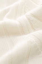 Close-up shot from above of the creamy white Brunello Cucinelli Cashmere Knit Polo Cream showing wide rib knit texture and soft touch.

Additional description:  
<p>Timeless essential for the refined men's wardrobe: BRUNELLO CUCINELLI has chosen pure cash