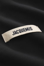 Jacquemus Half-zip jumper 'Gros Grain' black close-up from above showing Grosgrain logo stitching on heavy-quality pure cotton fabric.