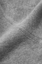 Close-up front view of the fine knit pattern on the Moorer Quarter-zip jumper 'Pienza' grey melange, made from a soft cashmere-wool blend with a slim fit, stand-up collar with velour leather reinforced zipper, and flexible ribbed cuffs, showcasing luxurio