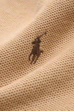 Close-up front view of Polo Ralph Lauren Half-zip jumper camel mottled showing textured cotton knit and tonal polo player stitching.

<p>A essential for mild days: This half-zip jumper by POLO RALPH LAUREN is made of high-quality cotton material and is a 