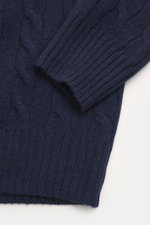 Close-up front view of Polo Ralph Lauren Troyer navy showcasing cable knit wool and cashmere fabric, ribbed cuff, and medium-fine knit pattern.