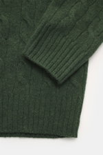 Close-up front view of Polo Ralph Lauren Troyer dark green showcasing medium-fine cable knit, ribbed cuffs, and wool-cashmere blend texture.