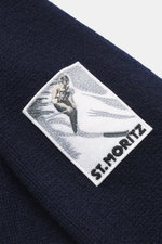 Close-up from above of the MC2 Saint Barth Quarter-zip jumper 'Buck' navy showing pure wool fabric with soft feel, medium coarse knit, ski motif patch, regular fit, stand up collar with zipper, and ribbed cuffs.
