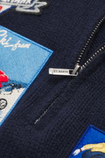 Close-up front view of the MC2 Saint Barth Quarter-zip jumper 'Buck' navy, showing pure wool fabric with a soft feel, medium coarse knit pattern, ski motif patches, regular fit, stand-up collar with zipper, and comfortable ribbed cuffs.