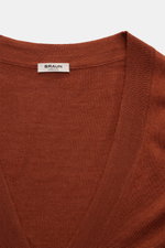 Close-up front view of the BRAUN Hamburg Cardigan rust brown showing fine knit V-neck and ribbed bands. Luxury you can feel on your skin, in a timeless and elegant design: This fine knit cardigan by BRAUN HAMBURG is defined by a fine blend of virgin wool,