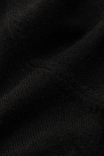 Nahaufnahme des feinen Strickbilds und weichen Griffs des schwarzen von Braun Cashmere Cardigans aus reinem mongolischem Cashmere.