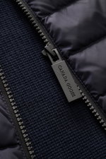 Close-up front view of the Canada Goose Cardigan 'Hybridge Knit' navy showing the textured pure wool knit, down front quilted microfibre, and robust zip pull.

Description: Make a smooth transition into the new season with the cardigan 'Hybridge Knit' fro