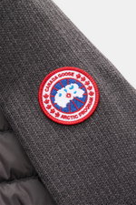 Close-up angled view of the Canada Goose Cardigan 'Hybridge Knit' dark grey showing textured pure wool knit sleeve with red, white, and blue Arctic Program patch; smooth transition into the new season with a down-lined front, slim fit, robust zip, high co
