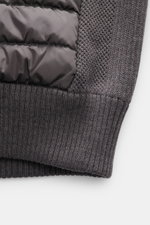 Close-up view of the Canada Goose Cardigan 'Hybridge Knit' dark grey showing pure wool knit with textured and contrasting knit pattern alongside down front quilted microfiber. Make a smooth transition into the new season with the cardigan 'Hybridge Knit' 