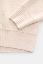 Close-up of the Stone Island Cardigan cream sleeve and cuff, photographed from above showing ribbed cuffs and soft virgin wool texture.

Description: <p>Comfortable essential: The cardigan from STONE ISLAND made of pure virgin wool impresses with warming 