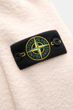 Close-up front view of the Stone Island Cardigan cream showing the black compass badge with green and yellow embroidery on soft pure virgin wool.

Description: <p>Comfortable essential: The cardigan from STONE ISLAND made of pure virgin wool impresses wit