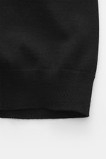 Emporio Armani Strickjacke schwarz, Detailaufnahme von unten, reine Schurwolle, weicher Griff, feines Strickbild, Slim Fit, verdeckter Zwei-Wege-Reißverschluss, gerippter Stehkragen, tonales Logo-Stitching, komfortable Rippbündchen.