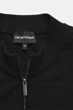 Close-up front view of Emporio Armani Cardigan black showing ribbed stand-up collar, two-way zipper, and fine textured knit pattern in pure virgin wool.
