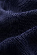 Close-up front view of Belstaff Cardigan 'Commander' navy, showing pure cotton fabric with slightly textured quality, fine rib stitch pattern, flat knit details, Slim Fit, concealed metal zipper, ribbed stand-up collar, BELSTAFF woven label on upper arm, 