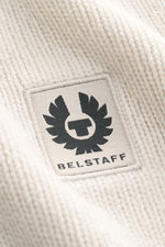 Close-up front view of Belstaff Cardigan 'Watch' cream showing pure wool coarse knit pattern, soft touch, rib knit elements, slim fit, stand-up collar, two-way zipper, BELSTAFF woven label on the chest, and flexible ribbed cuffs.