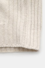 Close-up top-down view of the Belstaff Cardigan 'Watch' cream showing pure wool, soft touch, coarse knit pattern, rib knit elements, slim fit, stand-up collar, two-way zipper, BELSTAFF woven label on the chest, and flexible ribbed cuffs.