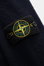 Close-up front view of Stone Island Cardigan navy showing compass badge on upper arm, made of pure virgin wool.

Description:  
<p>Comfortable essential: The cardigan from STONE ISLAND made of pure virgin wool impresses with a sporty look and warming wear