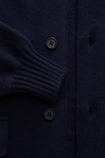 Close-up front view of Fioroni Cashmere cardigan navy showing soft pure cashmere fabric, fine knit, black buttons with leather-reinforced placket, ribbed cuffs, and patch pocket.