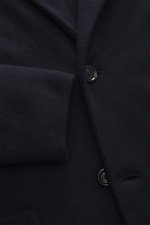 Close-up front view of Lardini Knitted Blazer Navy showing fine knit pattern, button, and cuff in pure wool slim fit style.

Description: <p>With a classic silhouette and made from pure wool, the knitted blazer by LARDINI brings style and personality to y