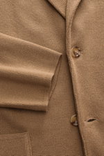 Close-up front view of the Lardini Knit blazer light brown showing fine knit pattern, two buttons, and patch hip pocket.

Description: <p>With a classic silhouette and made from pure wool, the knit blazer by LARDINI brings style and personality to your sm