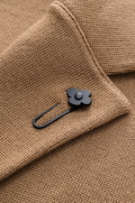 Close-up front view of Lardini Knit blazer light brown cuff showing fine knit pattern, soft wool texture, and flower pin detail.

Description:
<p>With a classic silhouette and made from pure wool, the knit blazer by LARDINI brings style and personality to