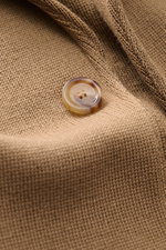 Close-up front view of Lardini Knit blazer light brown button and fine knit wool fabric texture with soft touch.

Description: 
<p>With a classic silhouette and made from pure wool, the knit blazer by LARDINI brings style and personality to your smart-cas
