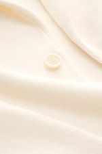 Close-up front view of the Lardini Knit blazer cream showing soft pure wool knit, fine pattern, button, and lapel detail.

Description: <p>With a classic silhouette and made from pure wool, the knit blazer by LARDINI brings style and personality to your s